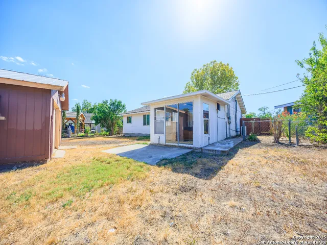 a view of a house with yard and garage