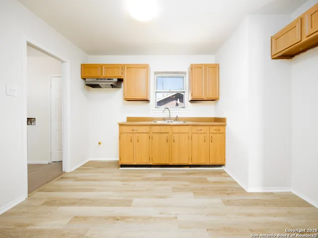 a view of a room with wooden floor and cabinet