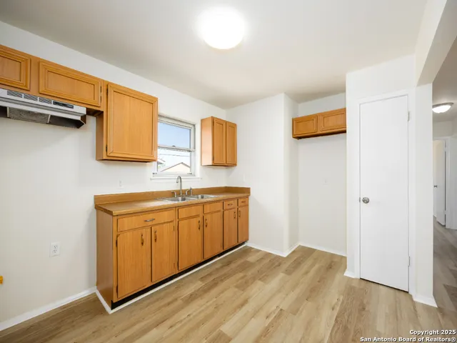 a spacious bathroom with a sink and a mirror