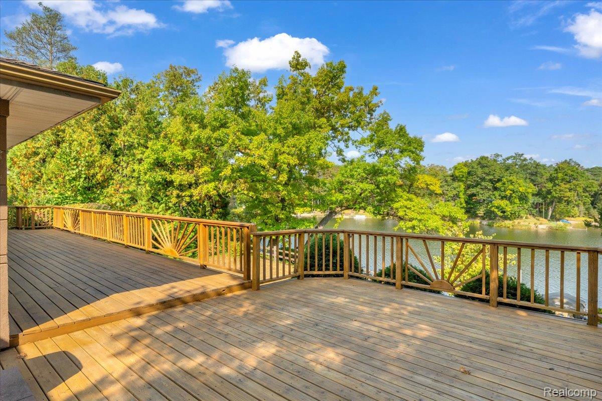 1156 Seneca Road Lake Orion, MI 48362 - Photo 32 of 50 Deck with a water view and view of wooded area