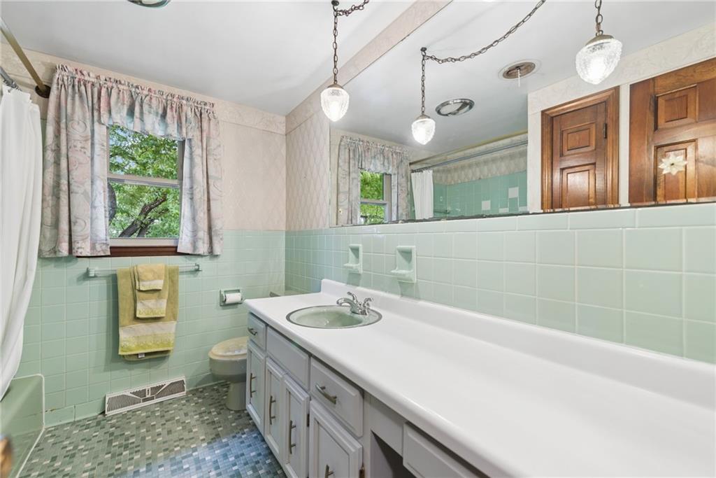 22 Buzzardtown Road Irwin, PA 15642 - Photo 24 of 44 a bathroom with a double vanity sink a mirror and a bathtub