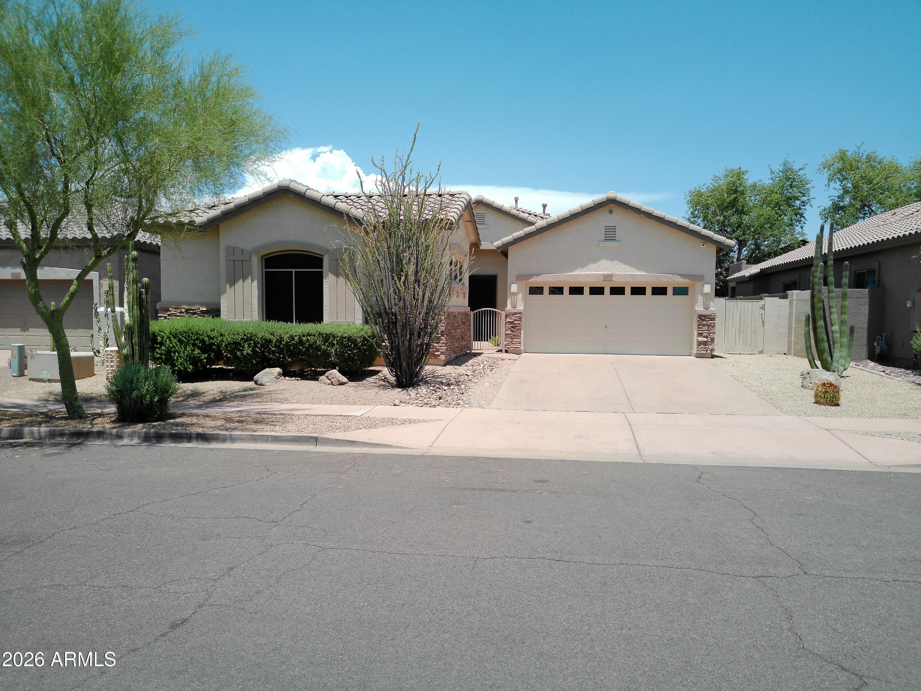 3018 West Sentinel Rock Road Phoenix, AZ 85086 - Photo 1 of 16 a front view of a house with a yard and garage