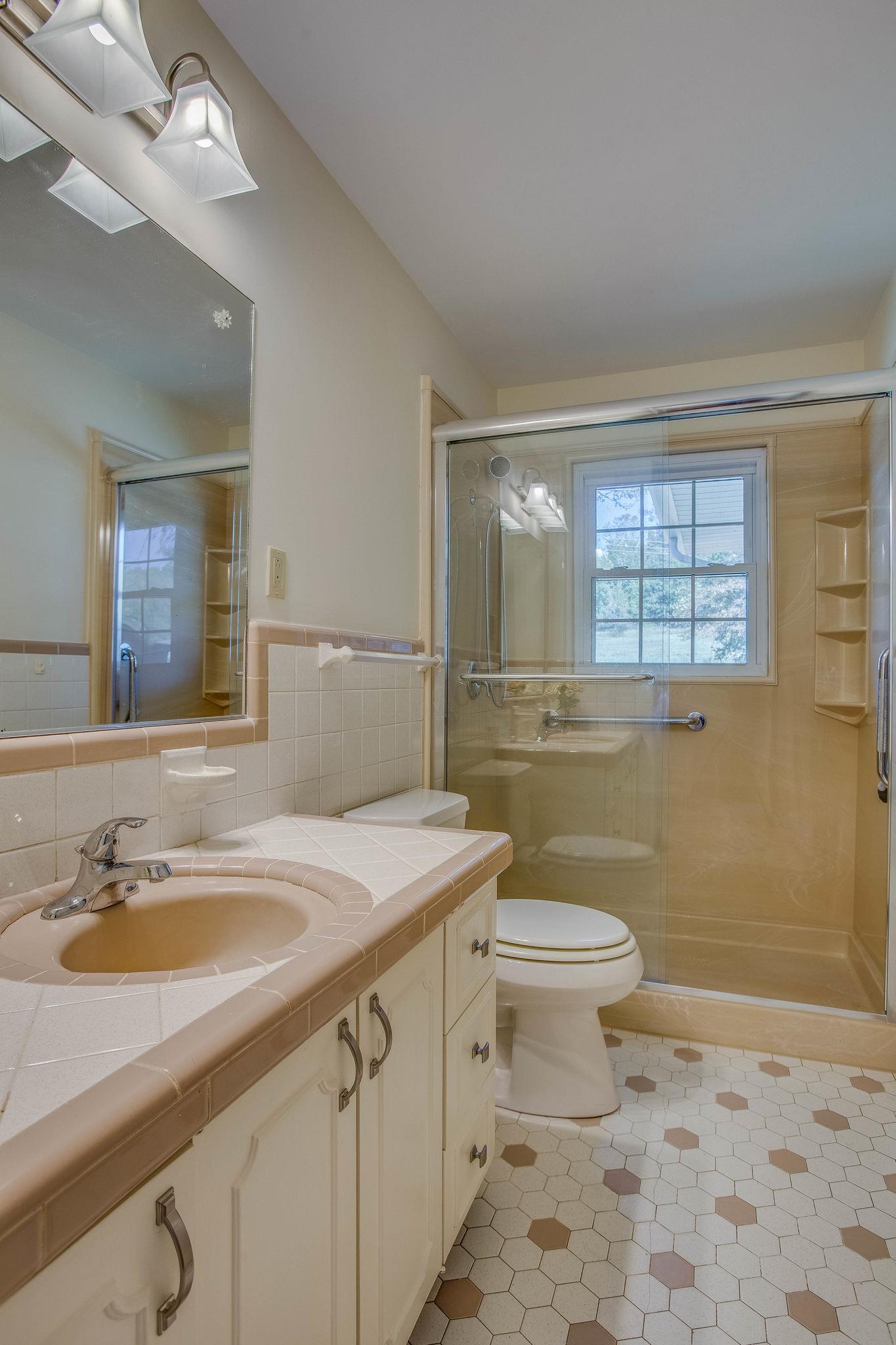 2173 Double Branch Road Columbia, TN 38401 - Photo 12 of 17 a bathroom with a sink a toilet and mirror