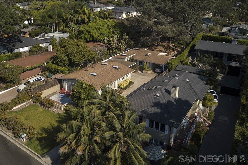 an aerial view of multiple houses with yard
