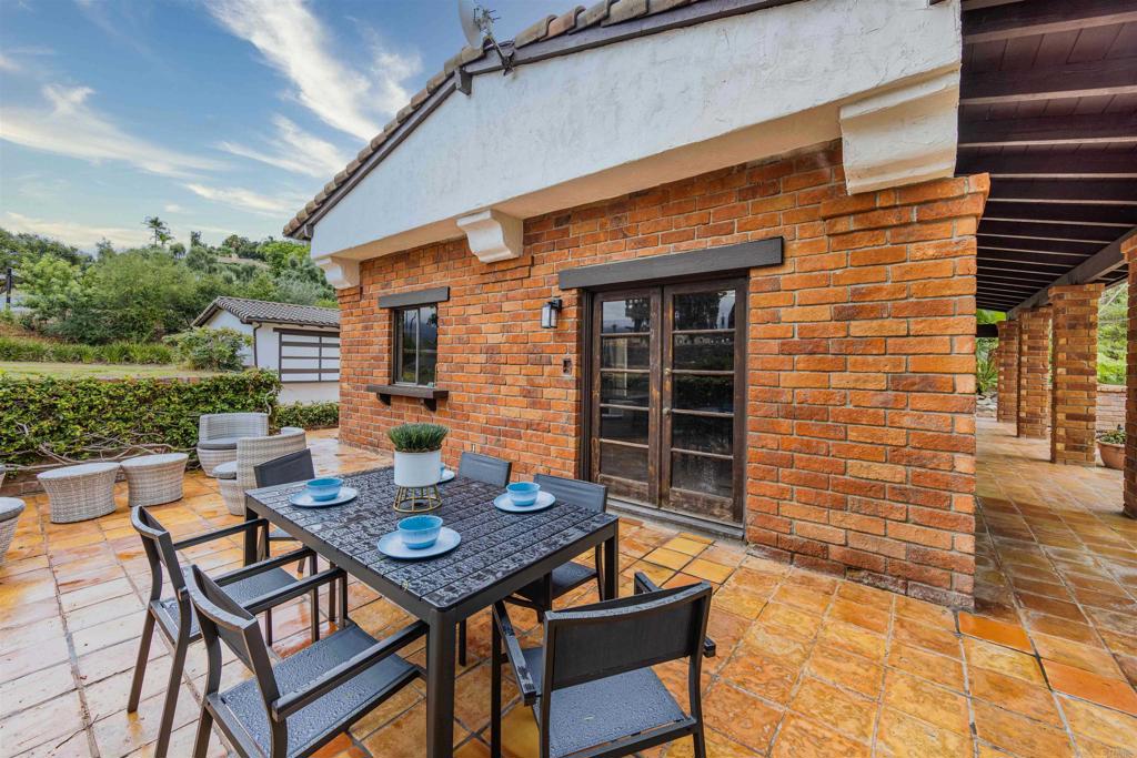 a backyard of a house with barbeque oven table and chairs