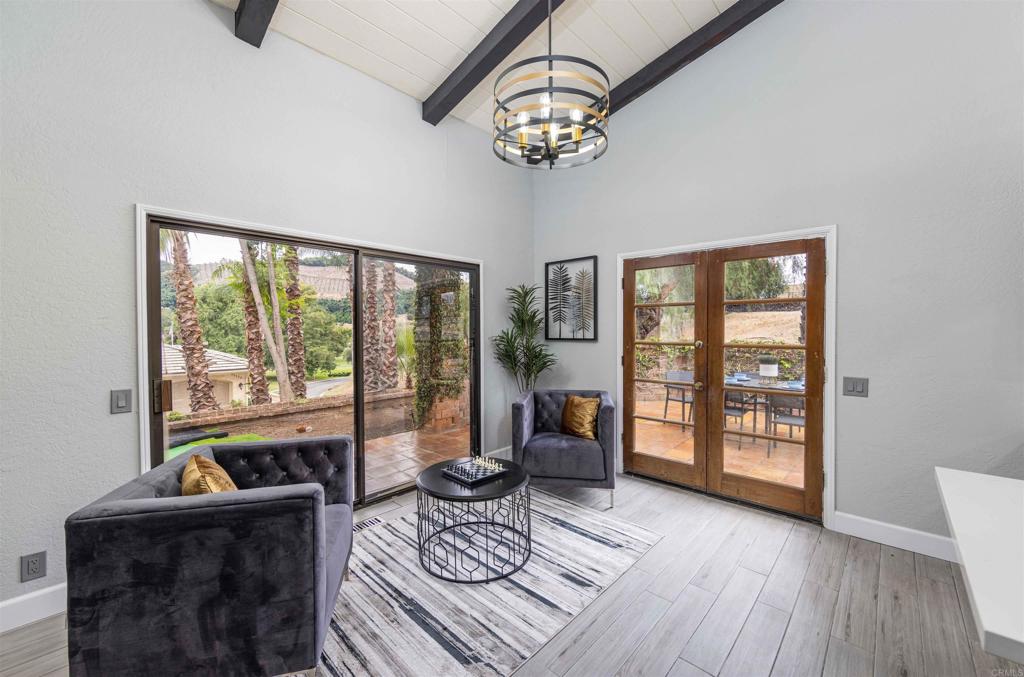 32404 Womsi Road Pauma Valley, CA 92061 - Photo 11 of 34 a living room with furniture and a floor to ceiling window