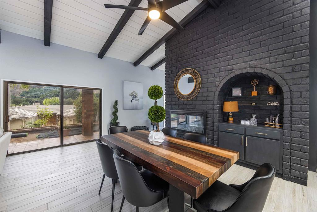 32404 Womsi Road Pauma Valley, CA 92061 - Photo 14 of 34 a dining room with a wooden table and chairs