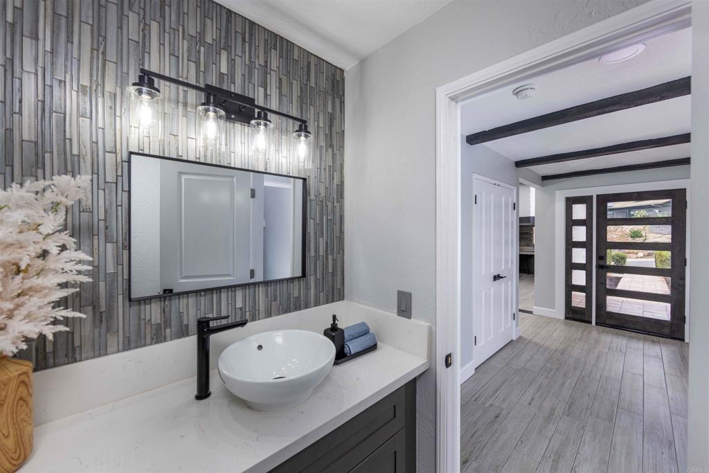 32404 Womsi Road Pauma Valley, CA 92061 - Photo 16 of 34 a bathroom with a sink a toilet and mirror