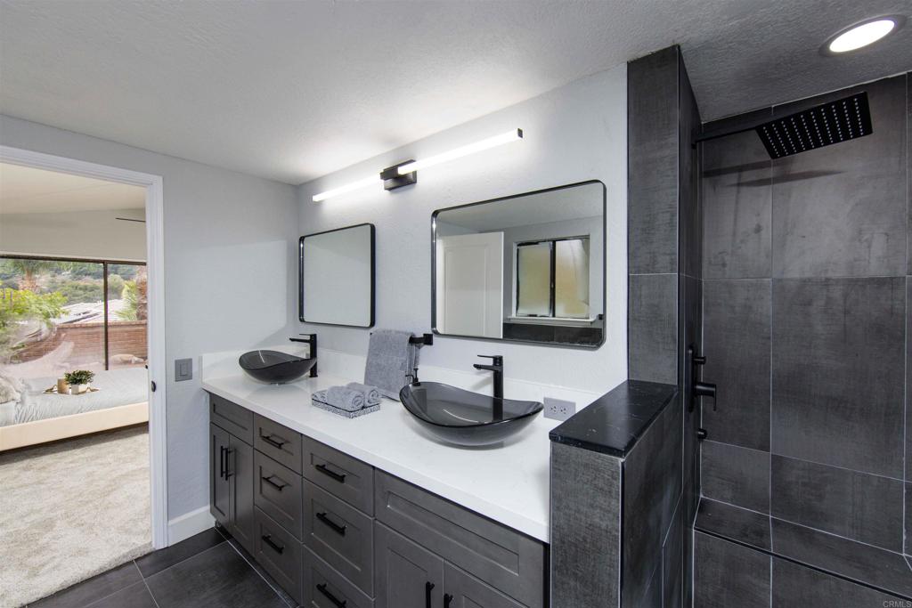 32404 Womsi Road Pauma Valley, CA 92061 - Photo 20 of 34 a bathroom with double vanity and a mirror