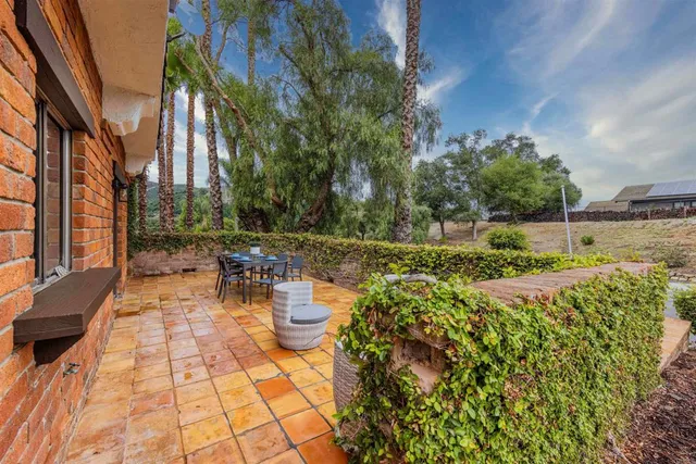 a view of a patio with table and chairs and potted plants