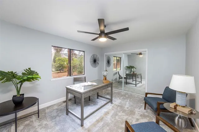 a living room with furniture a chandelier and a window