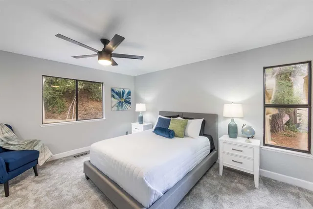 a bedroom with a large bed and a window