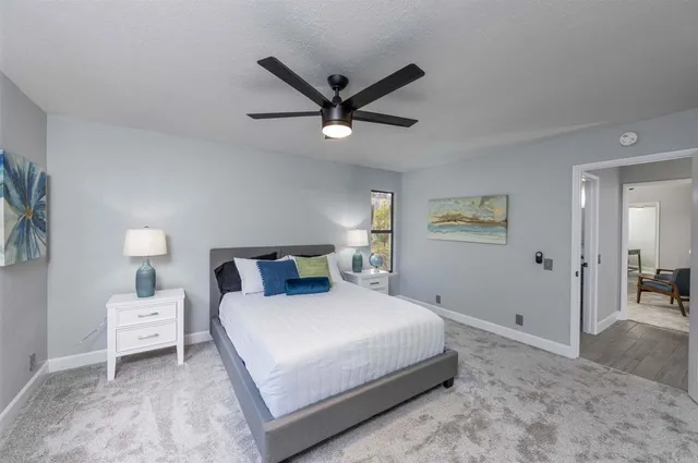 a bedroom with a bed and a chandelier