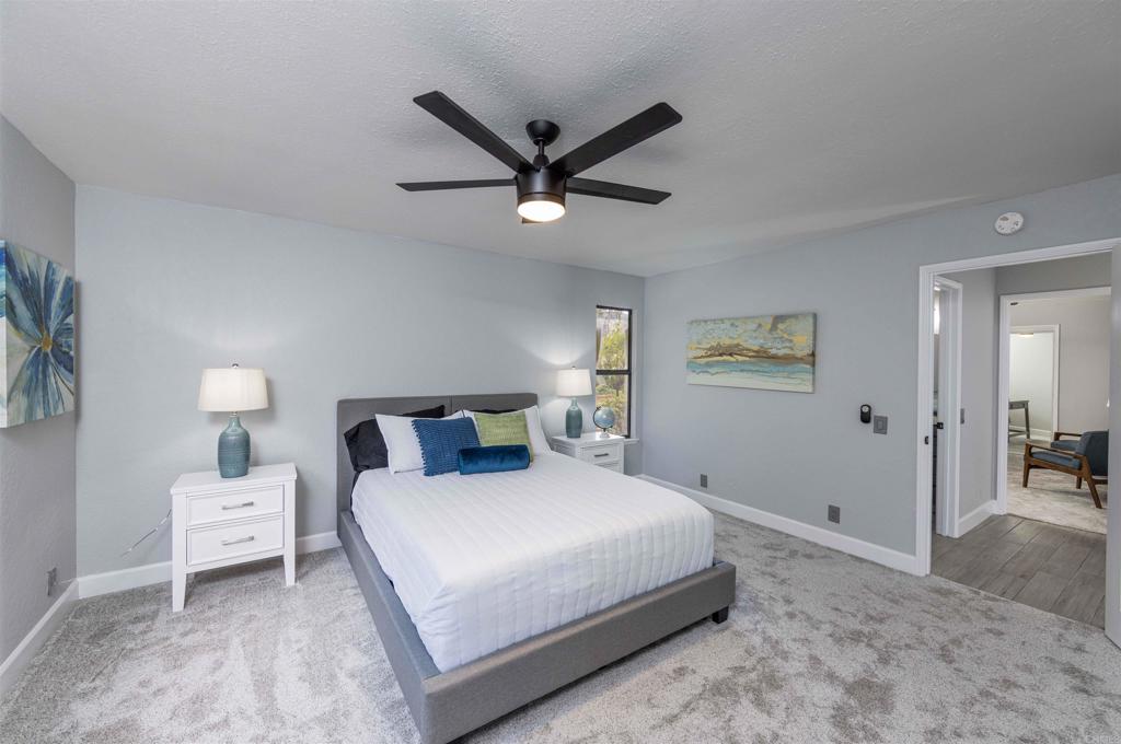 32404 Womsi Road Pauma Valley, CA 92061 - Photo 25 of 34 a bedroom with a bed and a chandelier