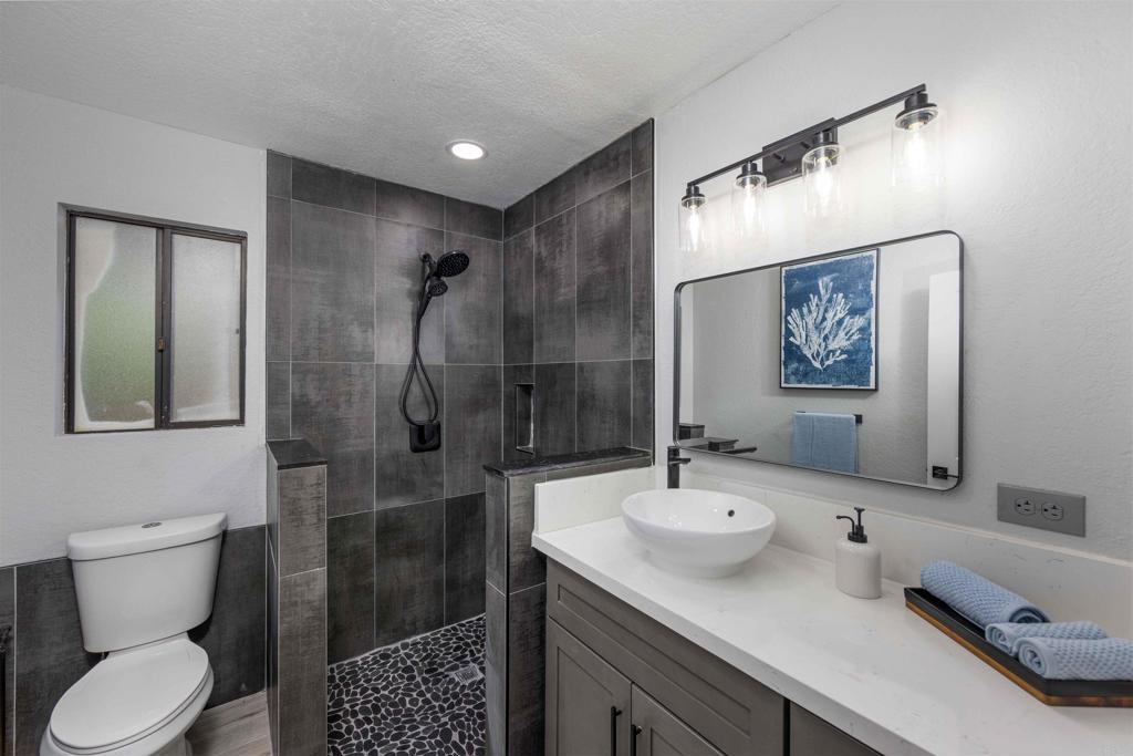 32404 Womsi Road Pauma Valley, CA 92061 - Photo 26 of 34 a bathroom with a sink toilet and shower