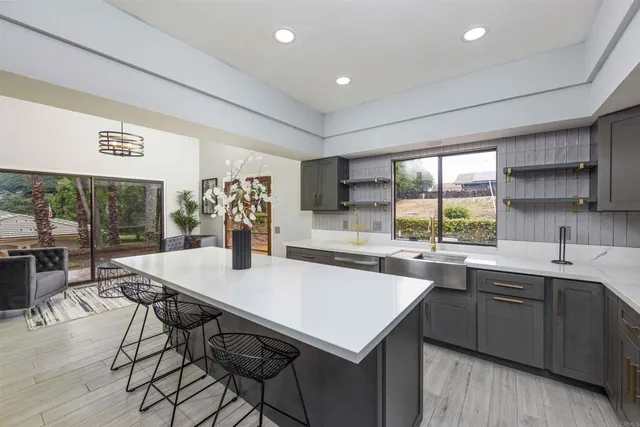 a kitchen with a sink a counter top space and stainless steel appliances
