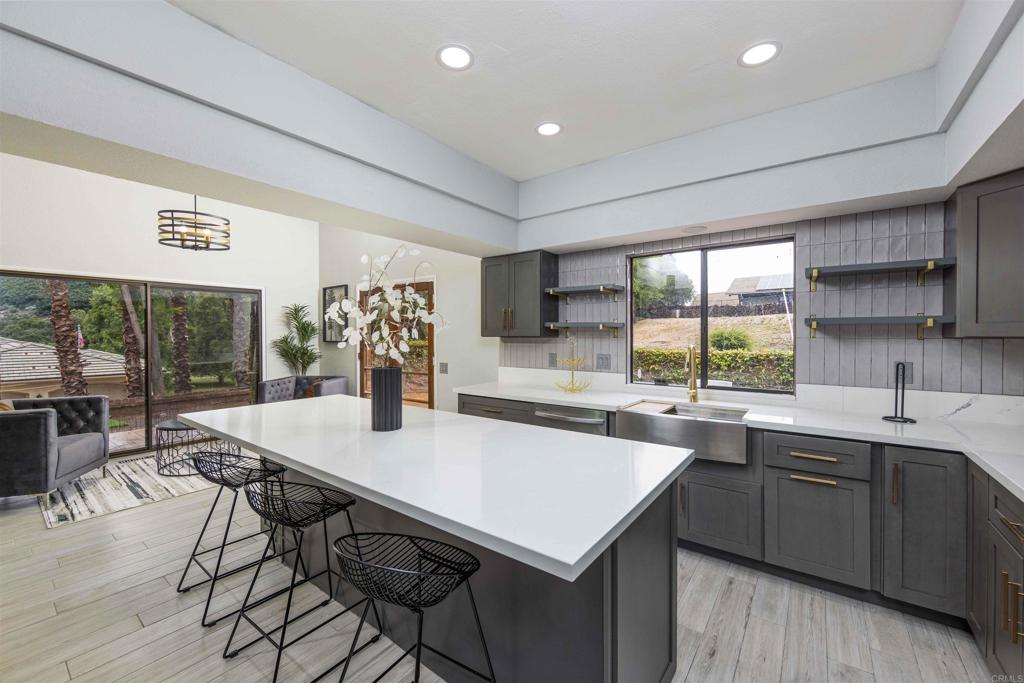 32404 Womsi Road Pauma Valley, CA 92061 - Photo 7 of 34 a kitchen with a sink a counter top space and stainless steel appliances