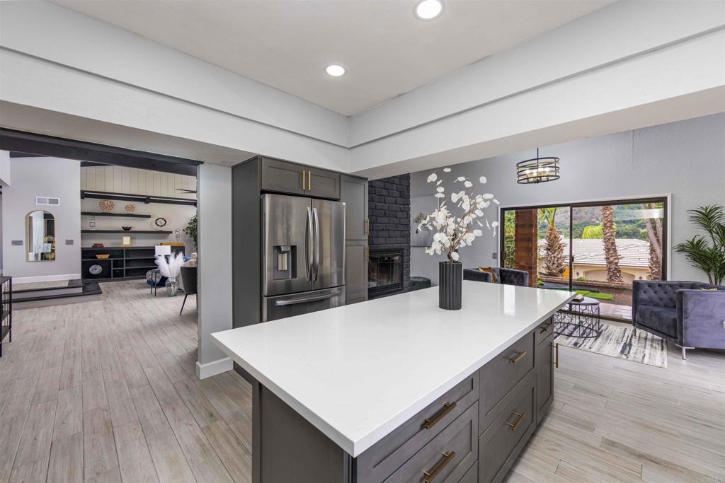 32404 Womsi Road Pauma Valley, CA 92061 - Photo 8 of 34 a living room with furniture a large window and wooden floor
