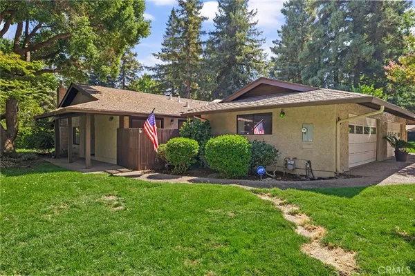 a front view of a house with a garden and plants
