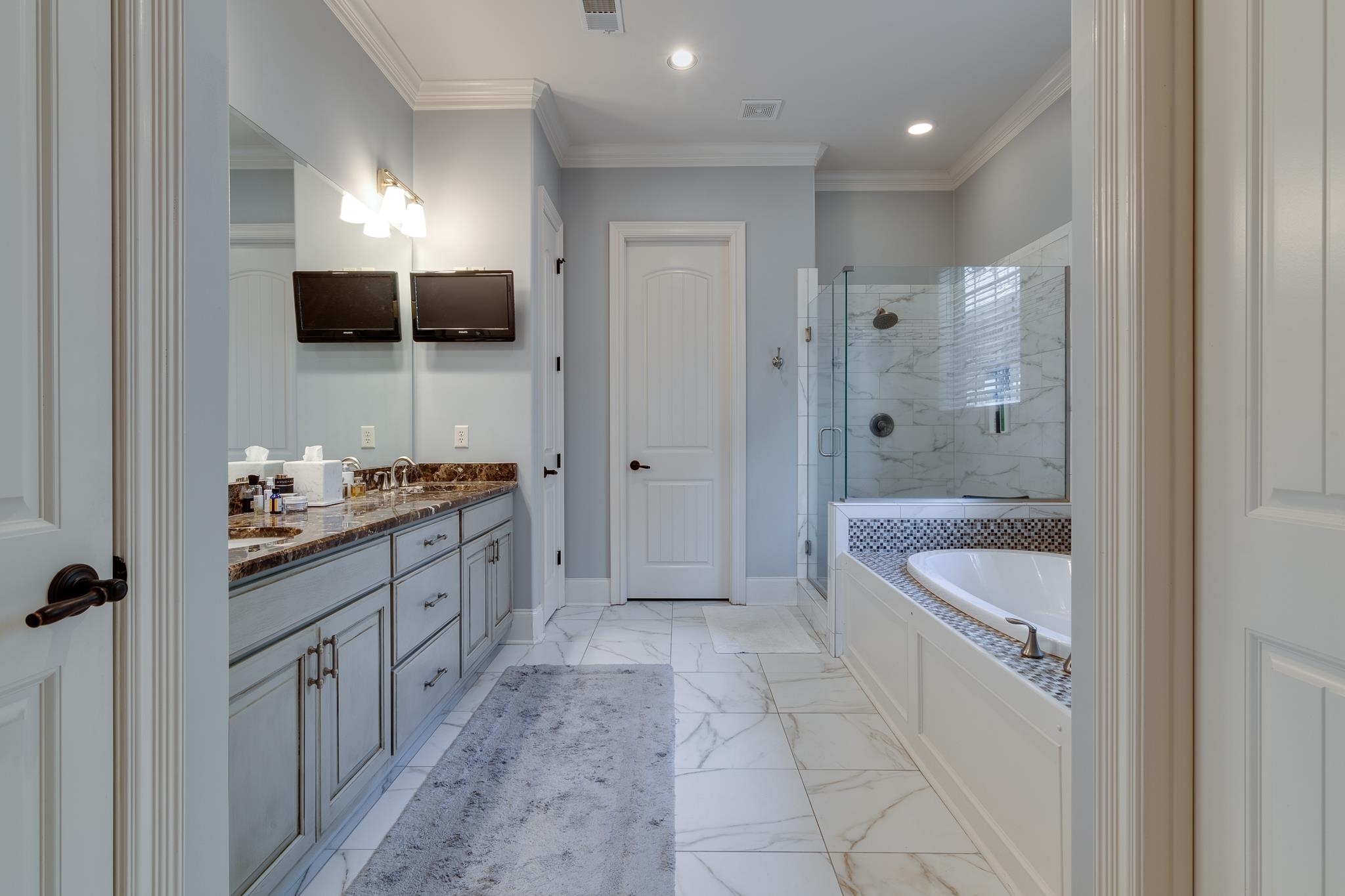 5245 Cole Road Memphis, TN 38120 - Photo 11 of 25 a large bathroom with a granite countertop tub sink a toilet and mirror