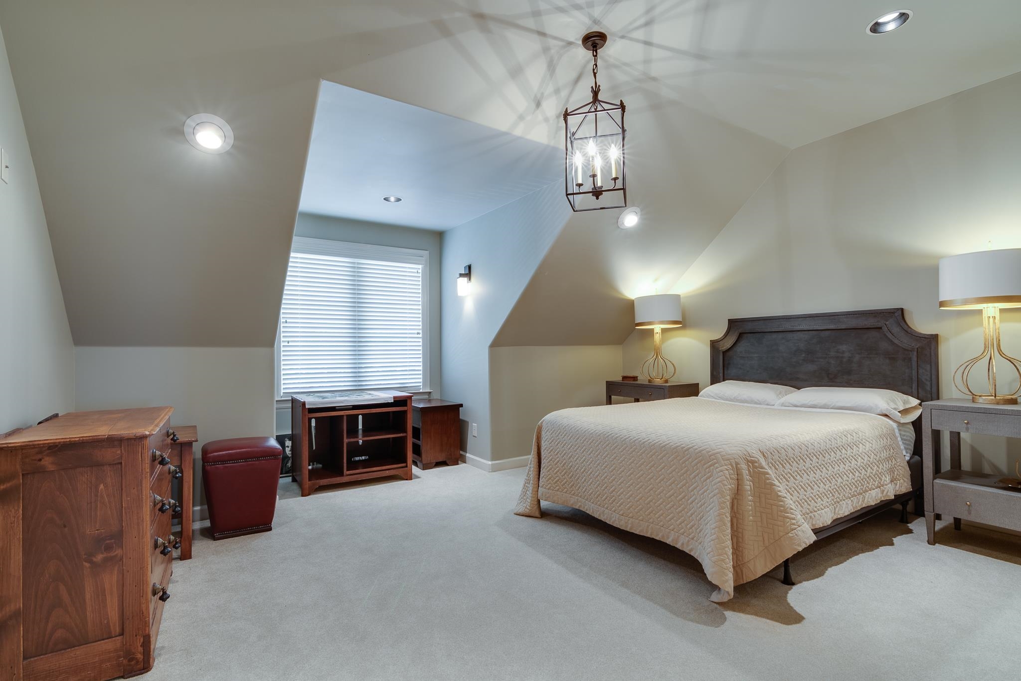 5245 Cole Road Memphis, TN 38120 - Photo 22 of 25 a spacious bedroom with a bed and a chandelier
