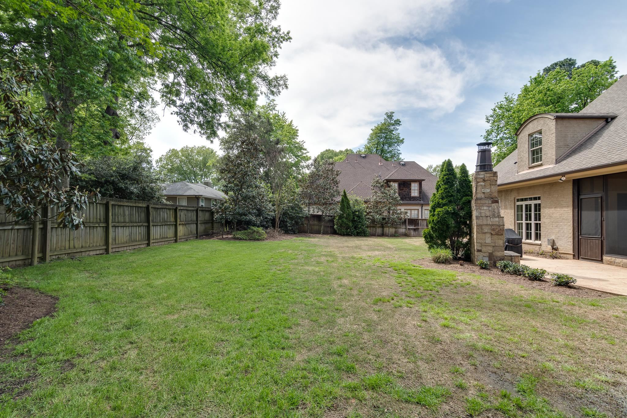 5245 Cole Road Memphis, TN 38120 - Photo 25 of 25 a view of a house with a yard and sitting area