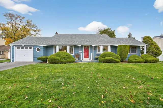 a view of a house with a big yard and potted plants