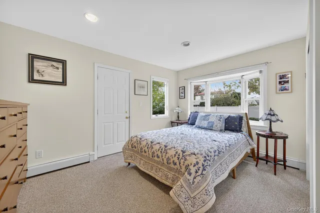 a bedroom with a large bed and a dresser