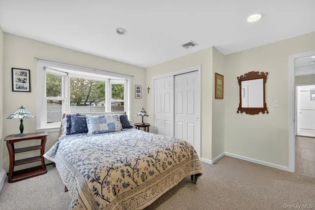 a bedroom with a large bed and a window