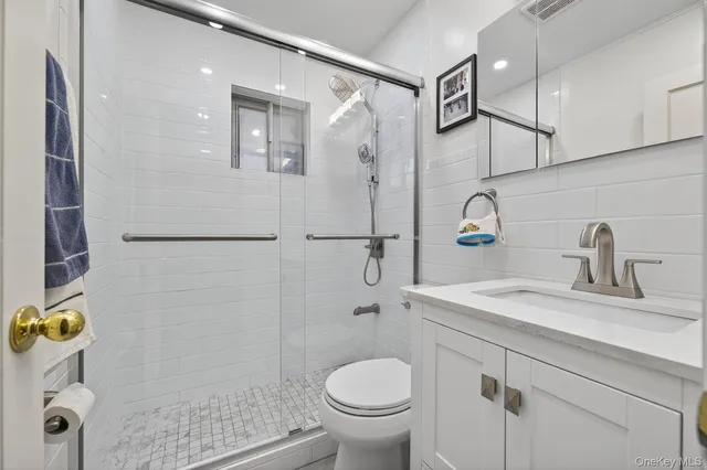 a bathroom with a sink toilet and shower