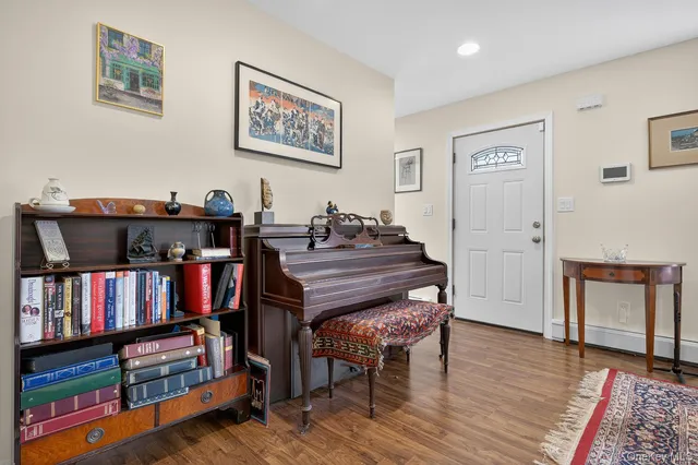 a view of a workspace with furniture and wooden floor