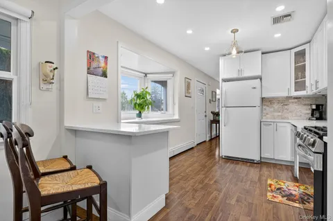 a kitchen with stainless steel appliances granite countertop a refrigerator and a stove top oven