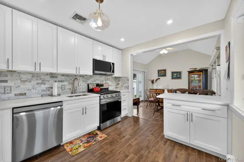 a kitchen with cabinets a sink and appliances