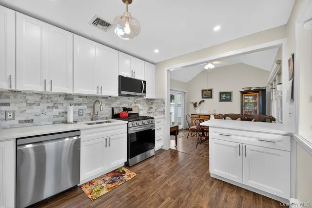 a kitchen with cabinets a sink and appliances