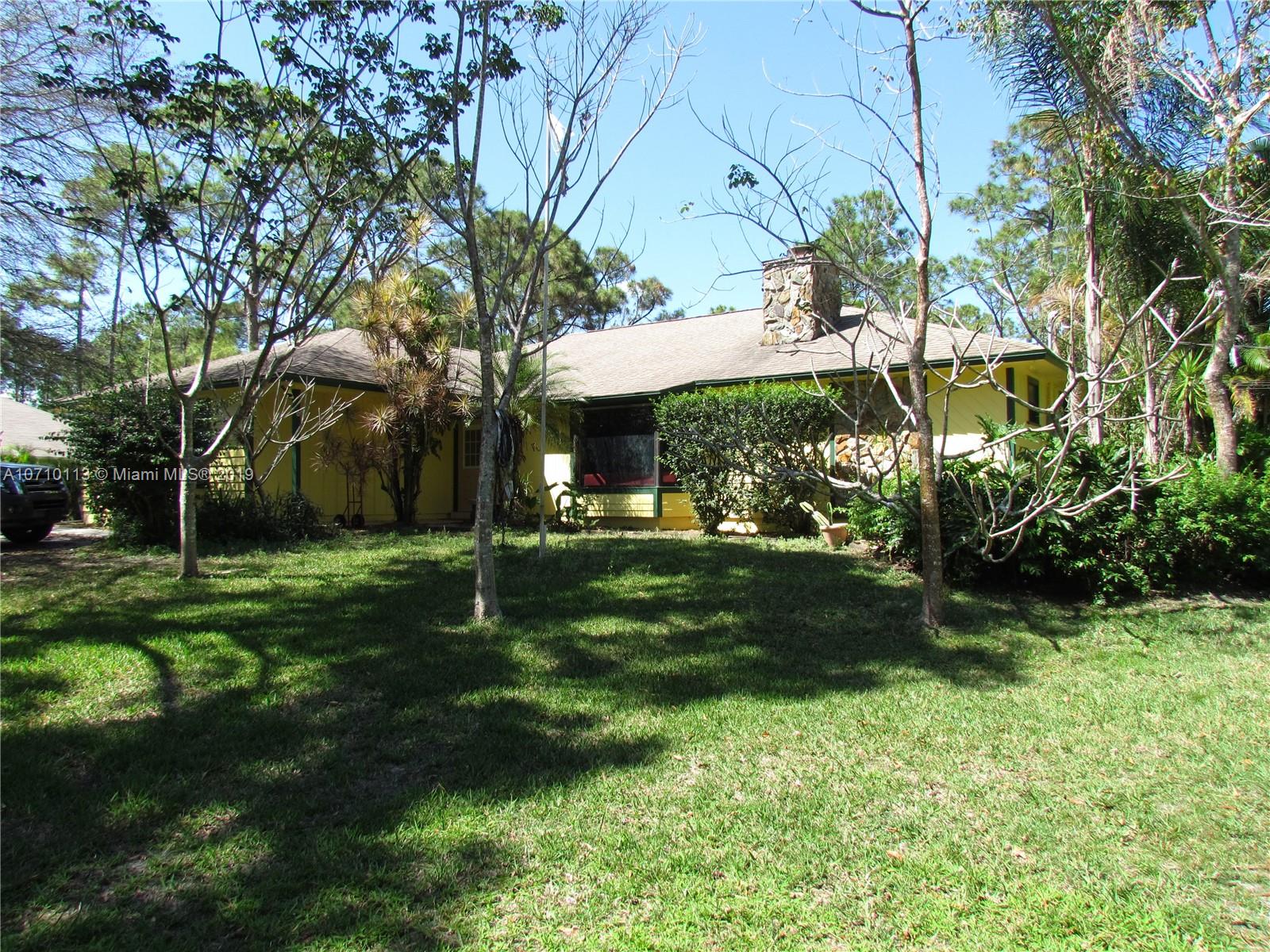 10825 Sandy Run Road Jupiter, FL 33478 - Photo 1 of 31 a view of a house with a yard
