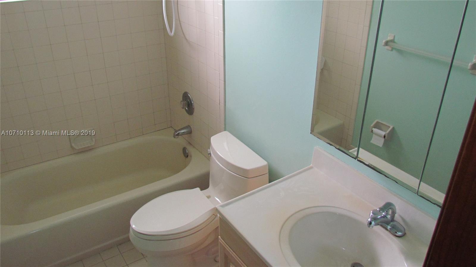 10825 Sandy Run Road Jupiter, FL 33478 - Photo 11 of 31 a white toilet sitting next to a bath tub