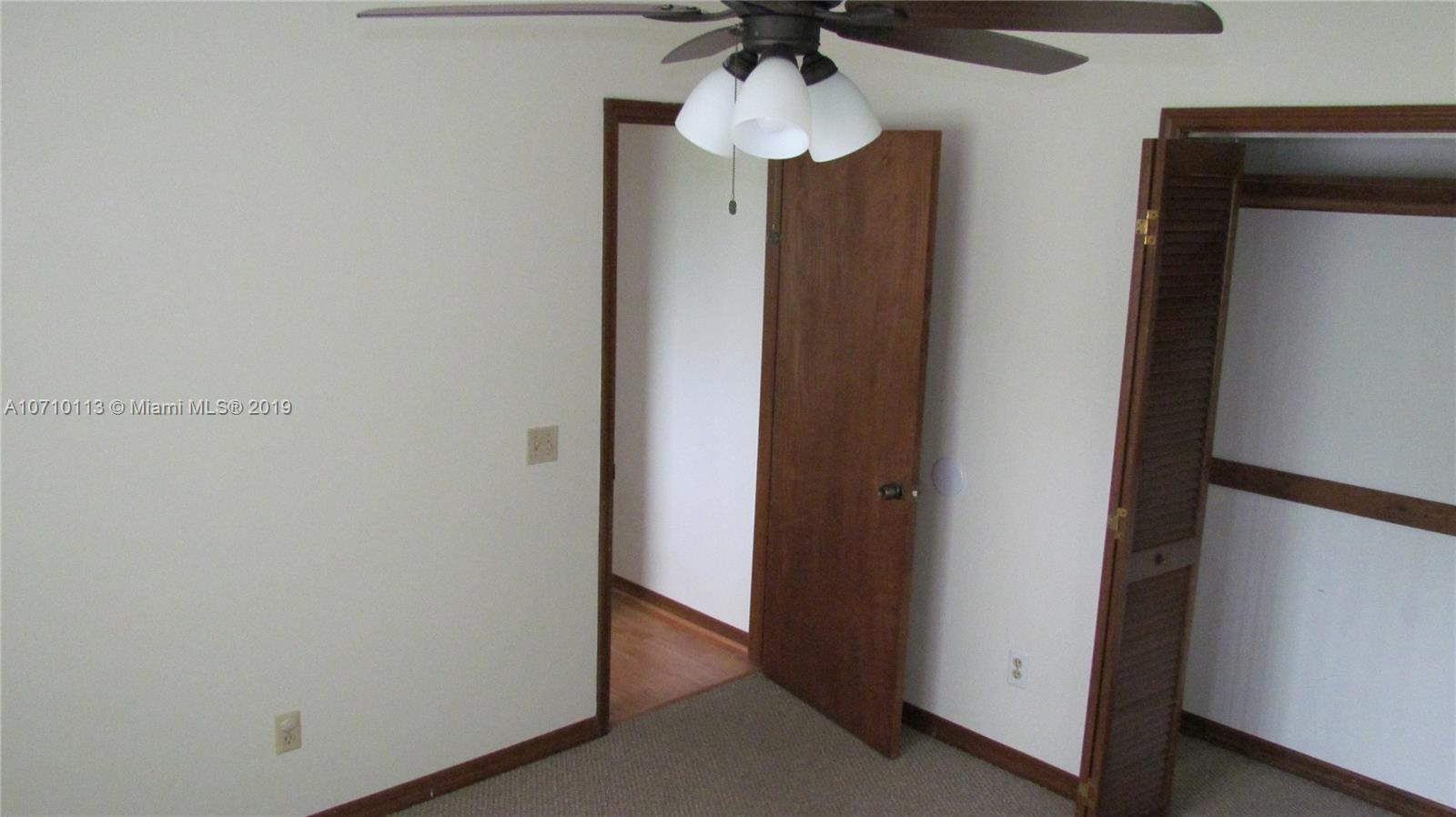 10825 Sandy Run Road Jupiter, FL 33478 - Photo 12 of 31 a view of hallway with chandelier fan