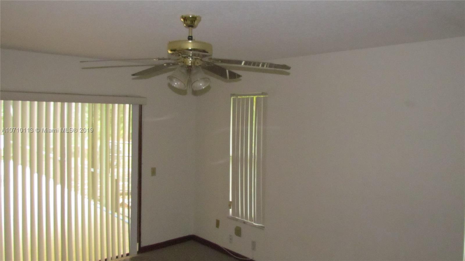 10825 Sandy Run Road Jupiter, FL 33478 - Photo 13 of 31 a view of a chandelier fan and window