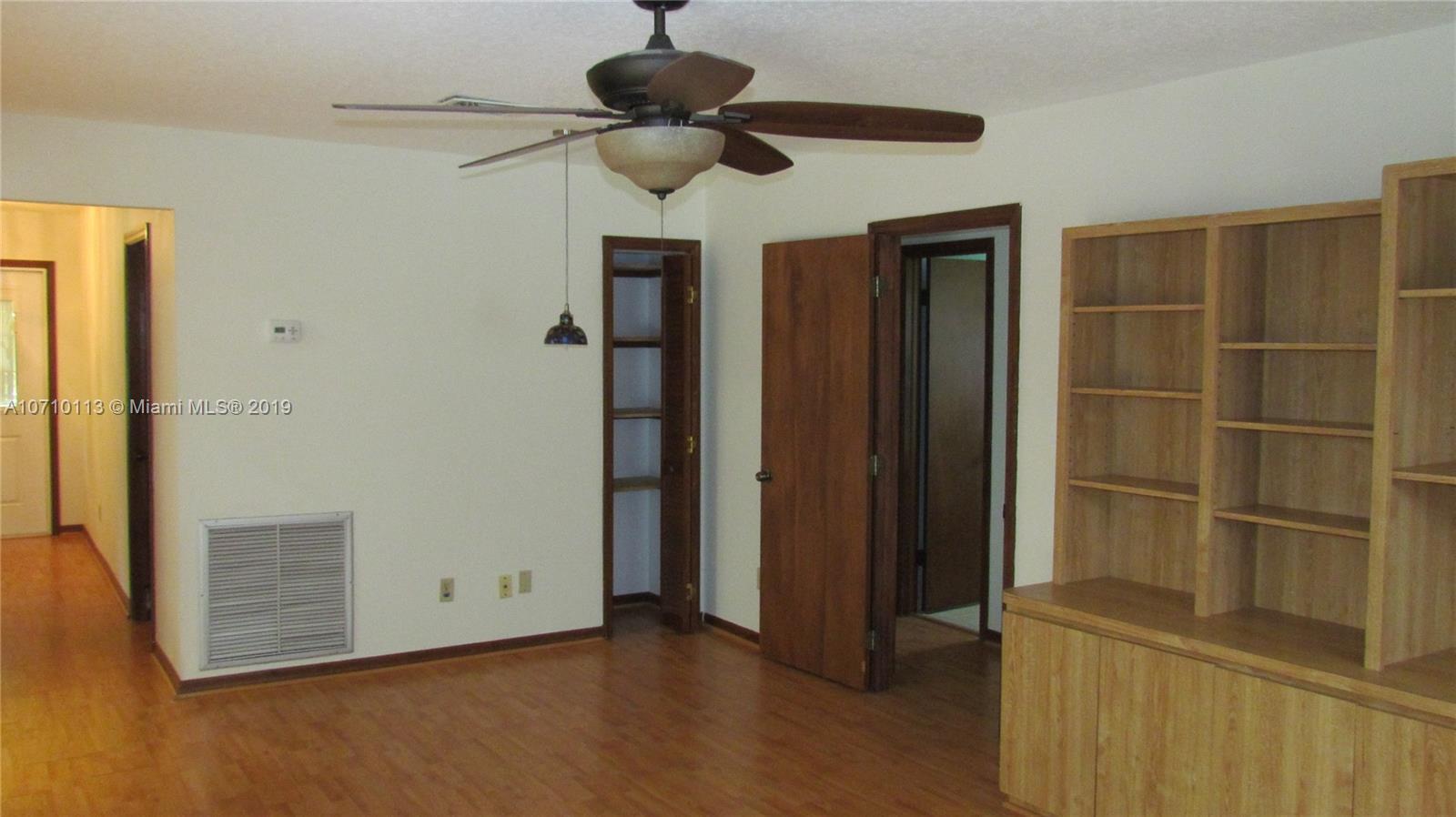 10825 Sandy Run Road Jupiter, FL 33478 - Photo 17 of 31 a view of an empty room with a fireplace