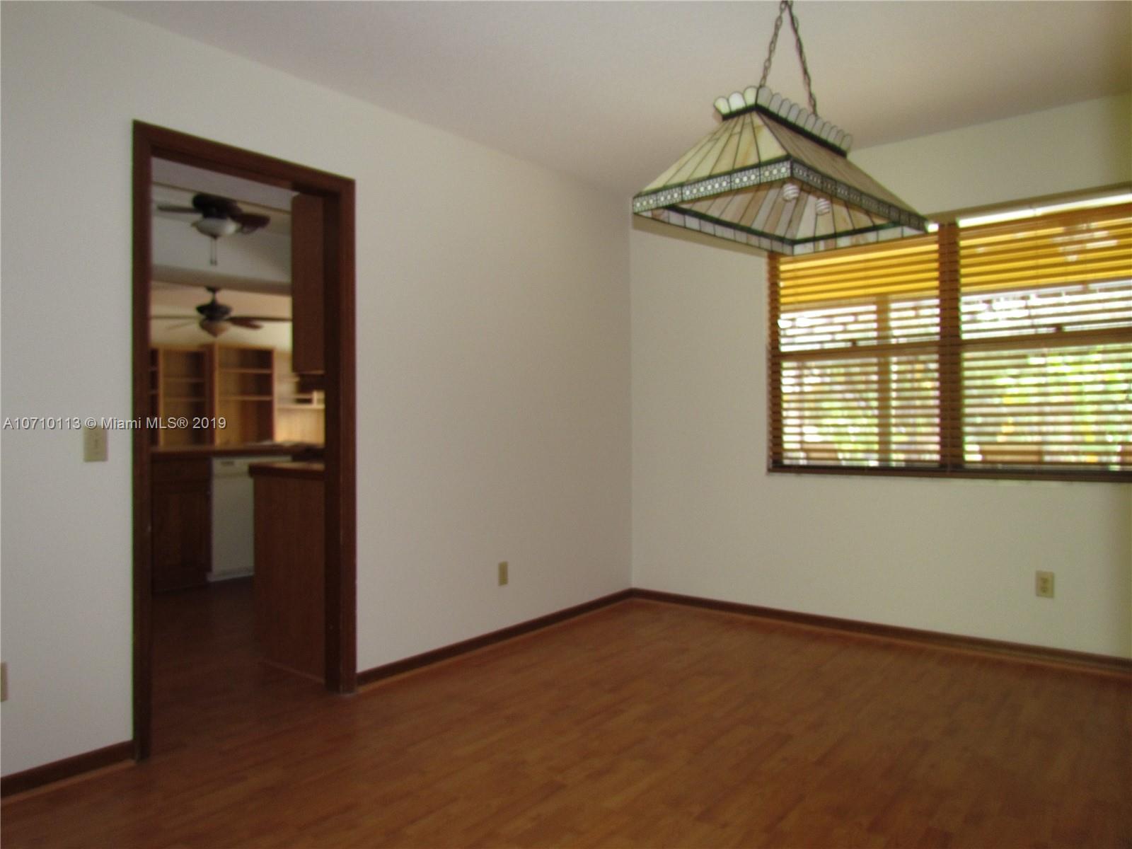 10825 Sandy Run Road Jupiter, FL 33478 - Photo 23 of 31 a view of empty room with wooden floor and windows