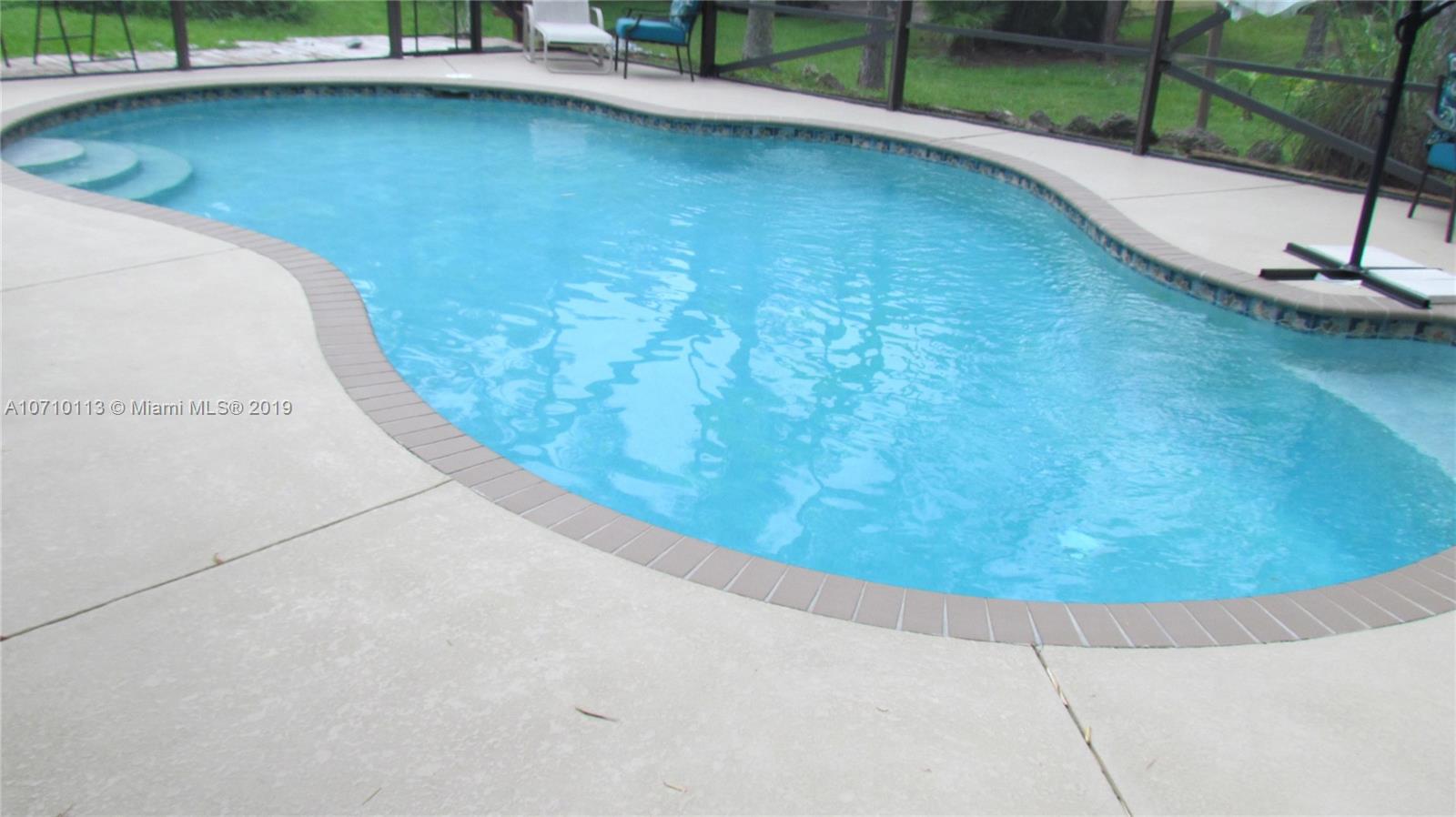 10825 Sandy Run Road Jupiter, FL 33478 - Photo 29 of 31 a view of a swimming pool with a yard