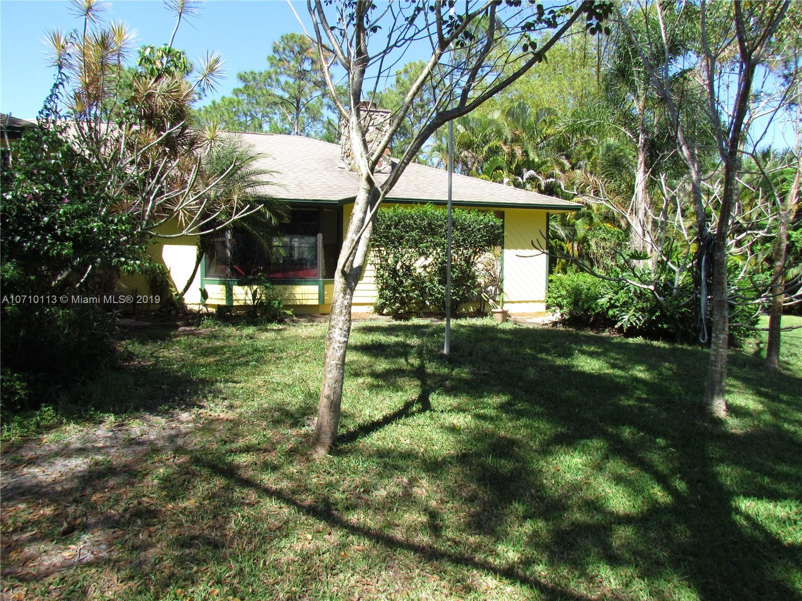 10825 Sandy Run Road Jupiter, FL 33478 - Photo 3 of 31 a view of a house with a yard