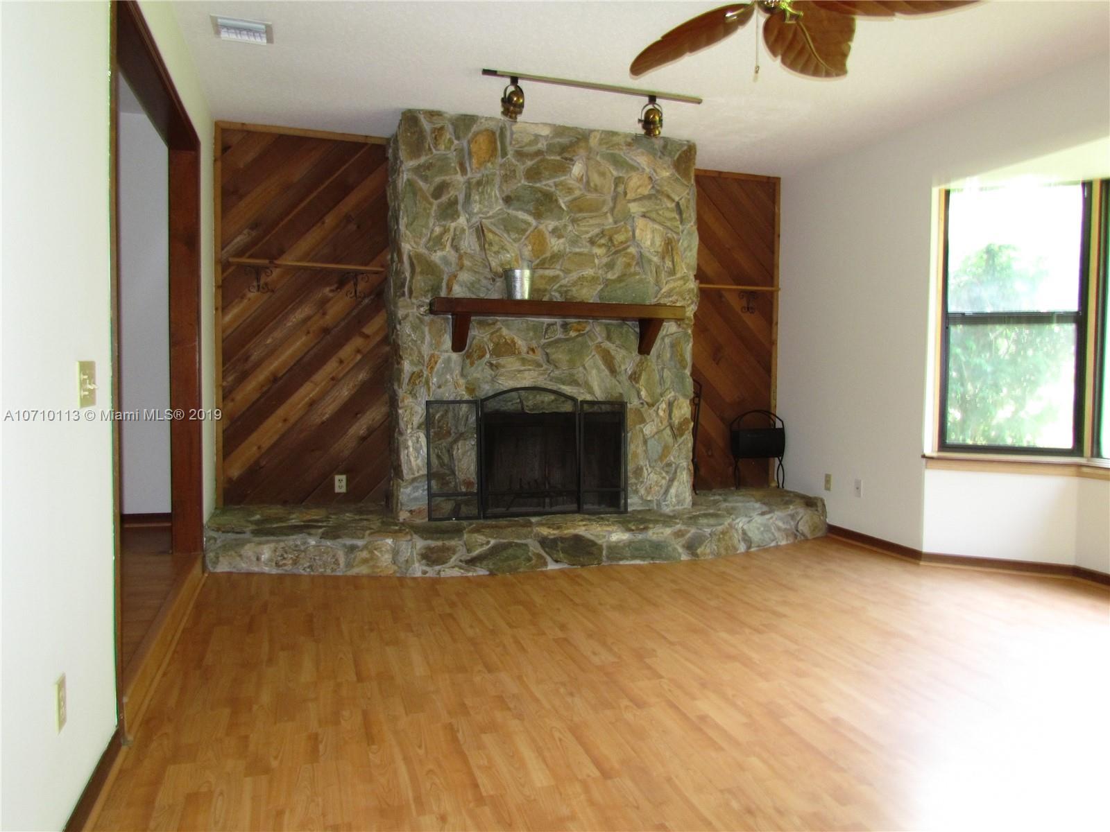 10825 Sandy Run Road Jupiter, FL 33478 - Photo 9 of 31 a view of an empty room with windows