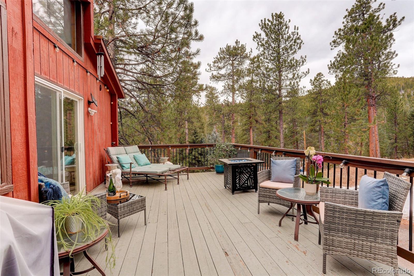 6997 South Columbine Road Evergreen, CO 80439 - Photo 33 of 40 a view of a chairs and table on the deck