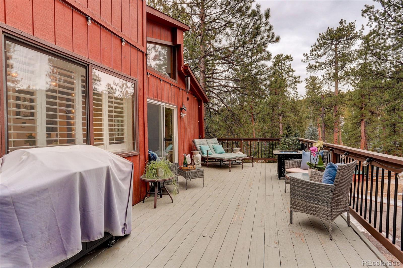 6997 South Columbine Road Evergreen, CO 80439 - Photo 34 of 40 a view of a patio with a table and chairs