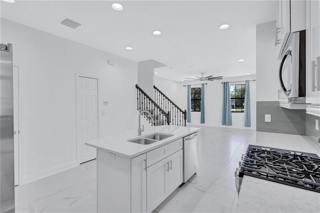 5830 Circa Fishhawk Boulevard Lithia, FL 33547 - Photo 17 of 37 a kitchen with white cabinets and window