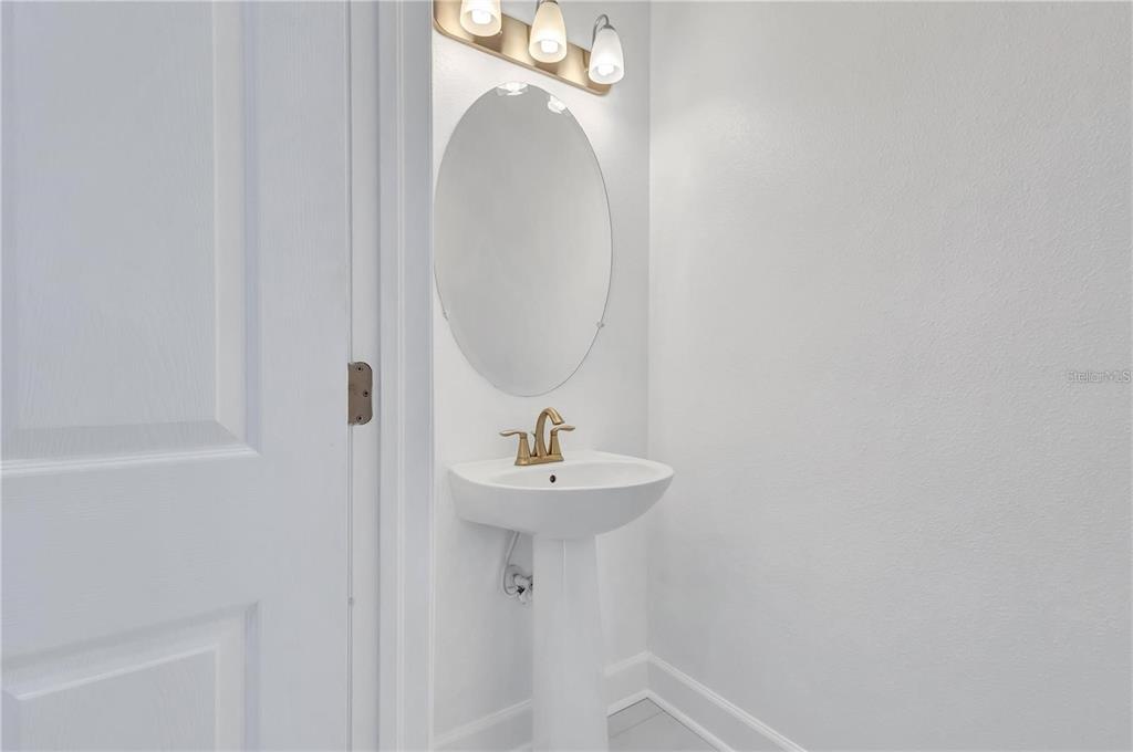 5830 Circa Fishhawk Boulevard Lithia, FL 33547 - Photo 20 of 37 a bathroom with a sink a mirror and shower
