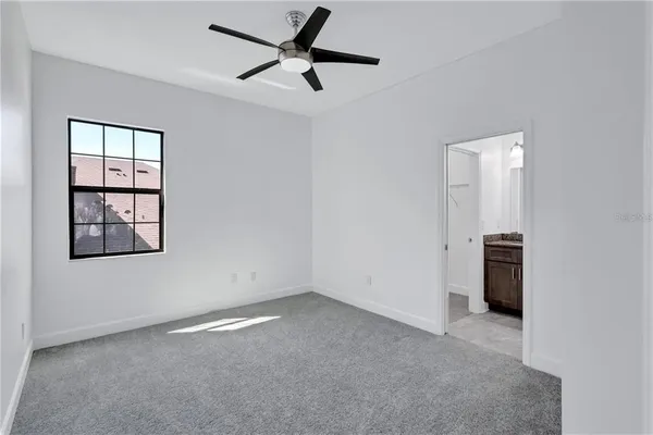 a view of room with hardwood ceiling fan