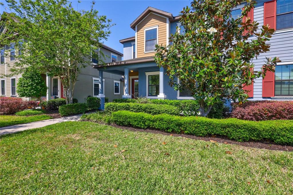 5830 Circa Fishhawk Boulevard Lithia, FL 33547 - Photo 3 of 37 a front view of a house with a garden and plants