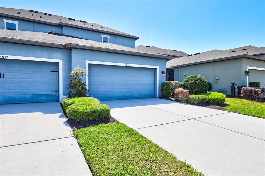5830 Circa Fishhawk Boulevard Lithia, FL 33547 - Photo 35 of 37 a front view of a house with a yard and garage